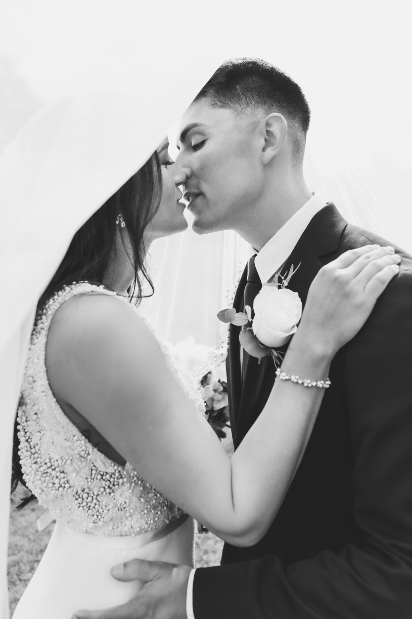 A beautiful candid shot of couple kissing under bride’s veil — Best Wedding photography and Cinematography in Colorado and Washington A beautiful candid shot of couple kissing under bride’s veil — Best Wedding photography and Cinematography in Colorado and Washington